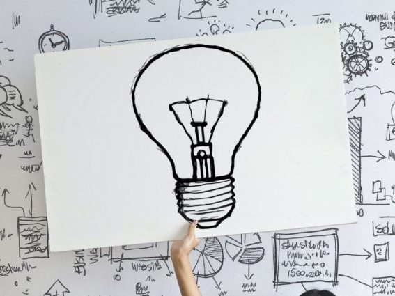 woman-draw-a-light-bulb-in-white-board-3758105