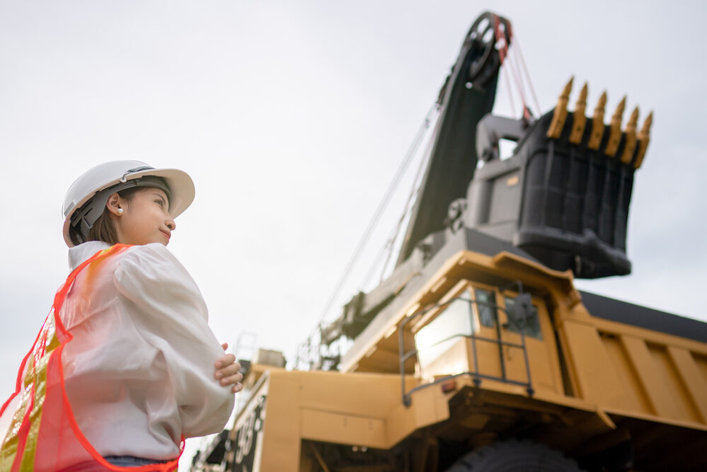 Worker in lignite or coal mining with the truck transporting coal.