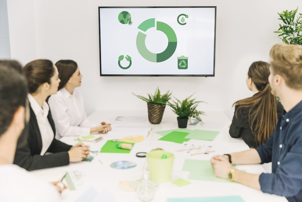 group-of-businesspeople-looking-at-natural-resources-icon-in-meeting