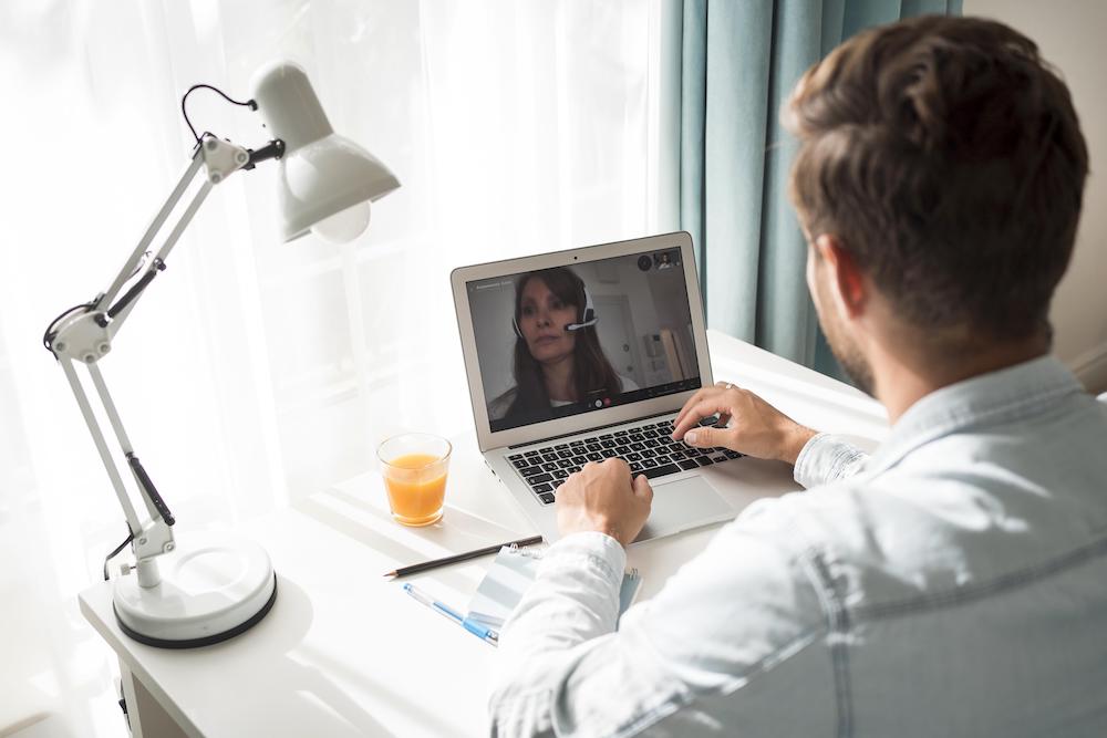 casual-adult-male-video-conferencing-at-home