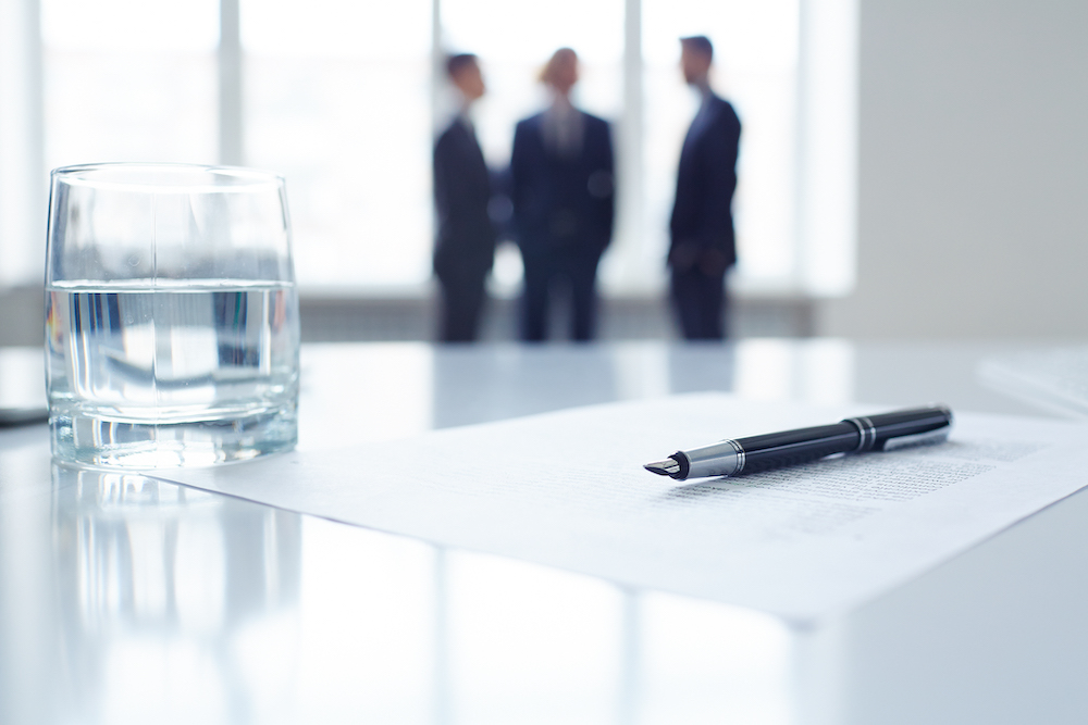 Pen on document and glass of water