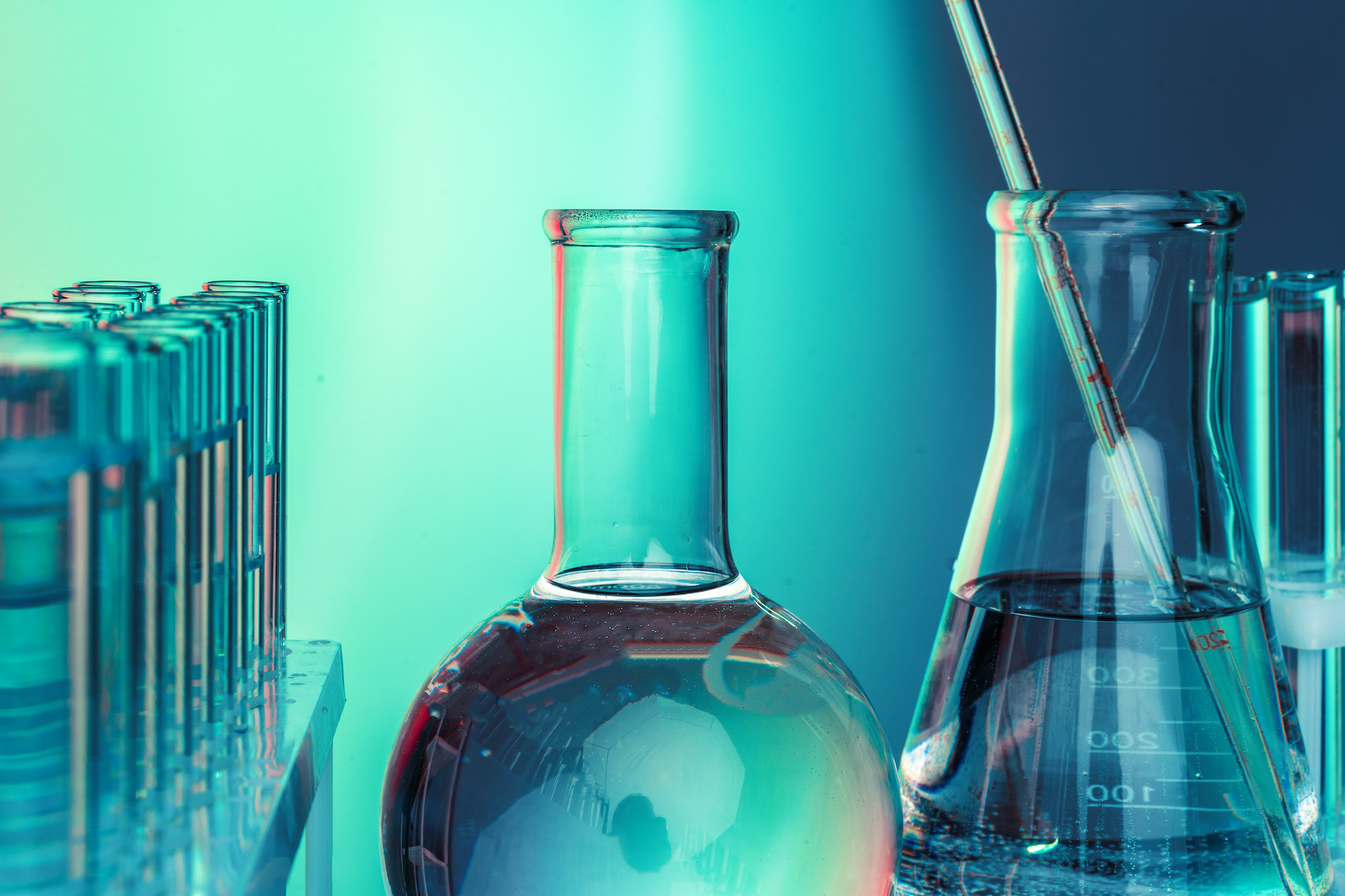 Laboratory chemistry glassware on green toned background