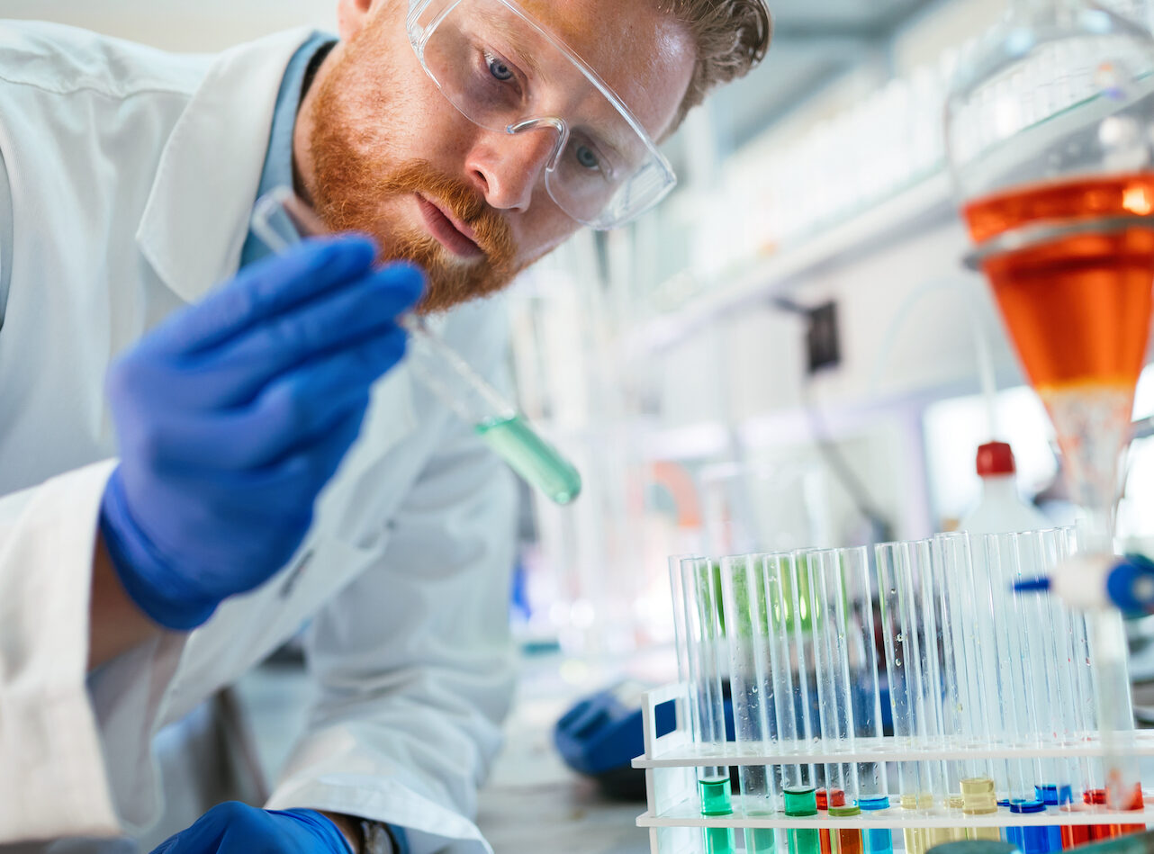 Handsome student of chemistry working with chemicals